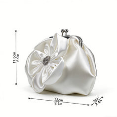 White satin evening bag with floral and rhinestone embellishments.